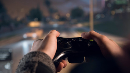 Gamepad in the hands in front of the monitor  © Digitalbarn