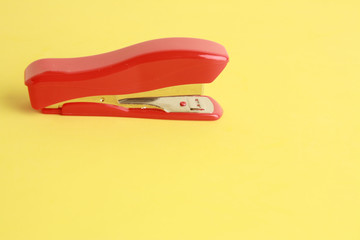 red stapler in color background