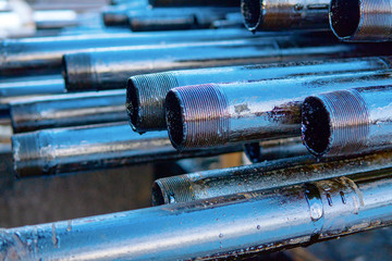 Pipe metal texture. Drillpipe on Oil Rig Pipe Deck. Rusty drill pipes were drilled in the well section. - obrazy, fototapety, plakaty