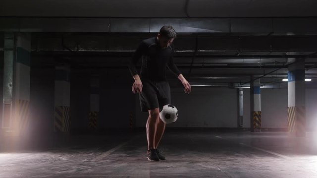 A young soccer man performing kicking tricks with the ball
