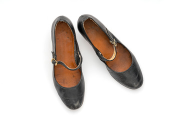 Fototapeta na wymiar pair of old black women's shoes, isolated on white