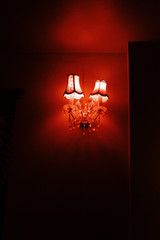 Fototapeta na wymiar wall sconce with crystal pendants and red lighting