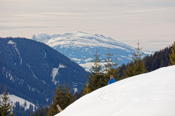 Fototapeta na wymiar Ski tourist passing by with views from Furkajoch alpine road towards Switzerland