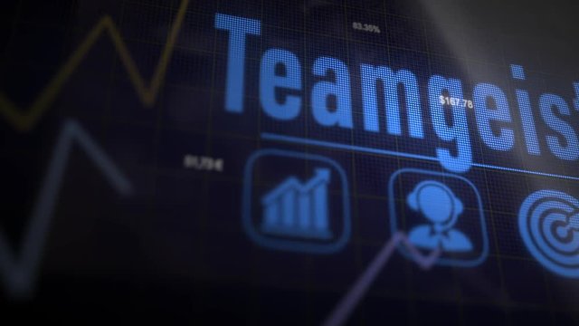 Teamgeist &ldquo;Team Spirit&rdquo; German business concept on a flashing computer monitor with moving graphs and data.