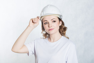 Young architect woman in white safety helmet hardhat on white background.