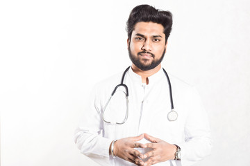 Fototapeta premium Handsome young doctor in a white coat with a stethoscope. Health care concept.