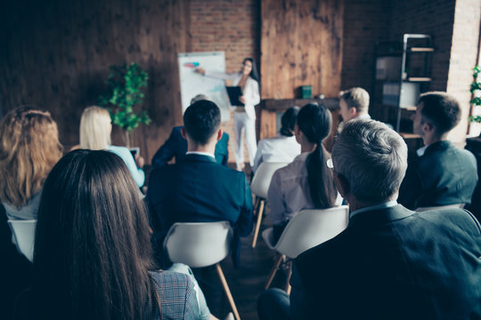 Rear back behind view of elegant stylish sharks executive managers listening educative course lecture economy finance corporate conference at industrial loft style interior work place station