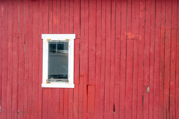 Fototapeta na wymiar White window on rough decay red wall