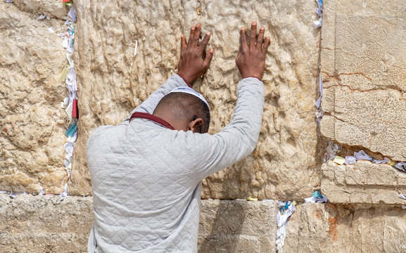 Undefined afro-american young man pray at the Western Wall. Jerusalem. Israel
