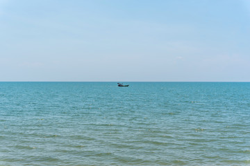 Fishing boat is out fishing in blue sea or ocean