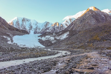 The river flowing from the glacier near the snow-white mountains
