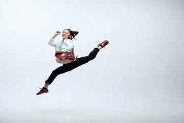 Winner of fears and doubts. Happy woman working at office, jumping and dancing in casual clothes or...
