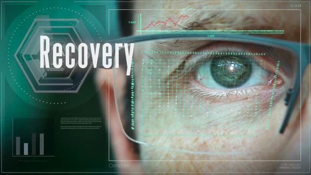 A close up of a businessman eye controlling a futuristic computer system with a Recovery Business concept.