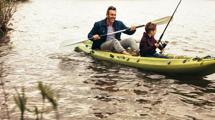 Fototapeta na wymiar Father and son enjoying fishing in the lake