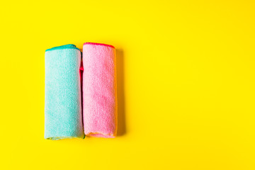 Colorful microfiber cloths on bright yellow