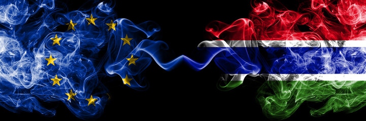 European Union vs Gambia, Gambian smoke flags placed side by side. Thick colored silky smoke flags of EU and Gambia, Gambian