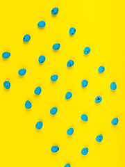 Blue eggs on bright yellow. Easter pattern