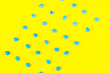 Blue eggs on bright yellow. Easter pattern