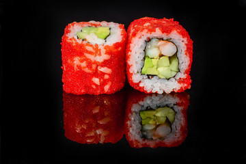 traditional fresh japanese sushi rolls on a black background
