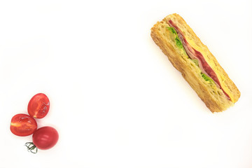 Sandwich with ham, cheese, tomatoes, lettuce, and crispy bread. Above view isolated on white background