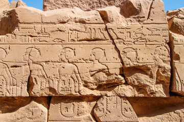 Old Egypt hieroglyphs carved on the stone wall in The Karnak Temple Complex, Luxor, Egypt (ancient Thebes).