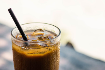 Fresh iced coffee on a wood table in a terrace in summer