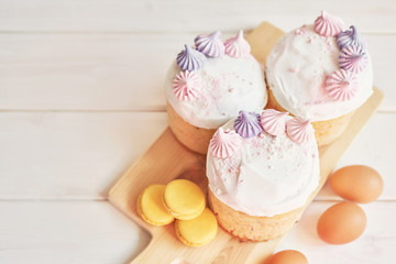 Easter cakes, eggs and macaroons on the table