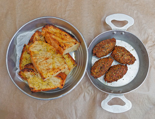 traditional greek fried pumpkin balls and roasted bread with olive oil and origan