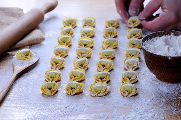 Preparing homemade tortellini.