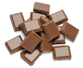 Milk organic chocolate pieces isolated on white background