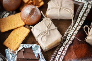 Romantic picnic concept. Cute sweet sugar snacks isolated on brown picnic blanket. Horizontal color photography.