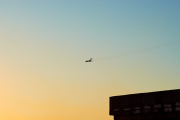 the plane flies high in the sky and the sun