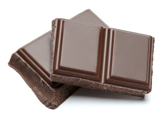 Dark organic chocolate pieces isolated on white background