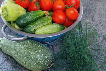 fresh vegetables and spices in an iron bowl on a wooden table