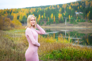 The girl in the pink dress in the autumn forest
