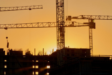 construction of the building cranes in the strongest light, otherwise