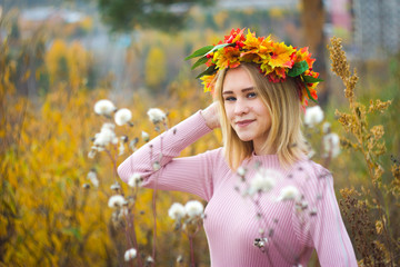 Girl in a wreath of autumn leaves