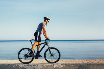 Fototapeta premium Man ride mountain bike on the road. Sport and active life concept.