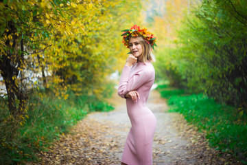 Girl in a wreath of autumn leaves
