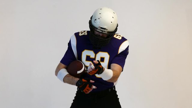 American Football Player wearing his sport dress on Black Background