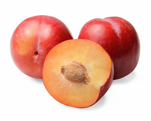 Red round plum. Whole and half. White isolated background. Close-up. Side view.