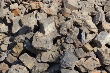 gray background of pieces of concrete and stones in a pile of garbage