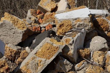 gray background of pieces of concrete and stones in a pile of garbage on the street