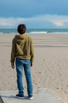 young man from behind on the beach