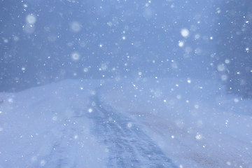 snow and fog on the winter road landscape / view of the seasonal weather a dangerous road, a winter lonely landscape
