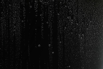 black wet background / raindrops for overlaying on window, concept of autumn weather, background of drops of water rain on glass transparent