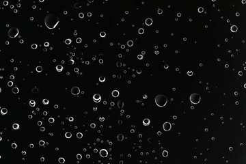 black wet background / raindrops for overlaying on window, concept of autumn weather, background of drops of water rain on glass transparent