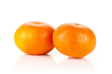 Group of two whole fresh orange mandarine isolated on white background