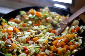 Vegetable and champignon mushroom stir fry in wok. Selective focus.