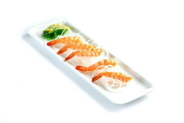 shrimps with lemon on a rectangular plate on an isolated white background